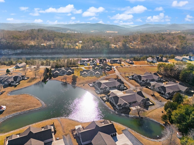 birds eye view of property featuring a water and mountain view