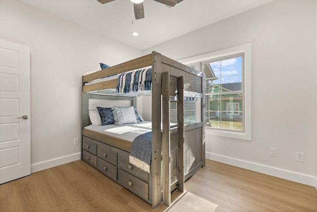 bedroom with ceiling fan and light wood-type flooring