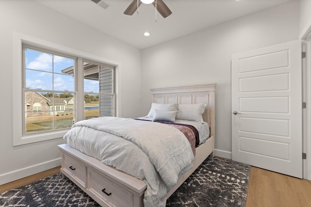 bedroom with wood-type flooring and ceiling fan