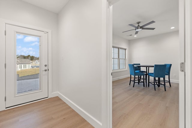 interior space featuring ceiling fan, light wood-type flooring, and a wealth of natural light