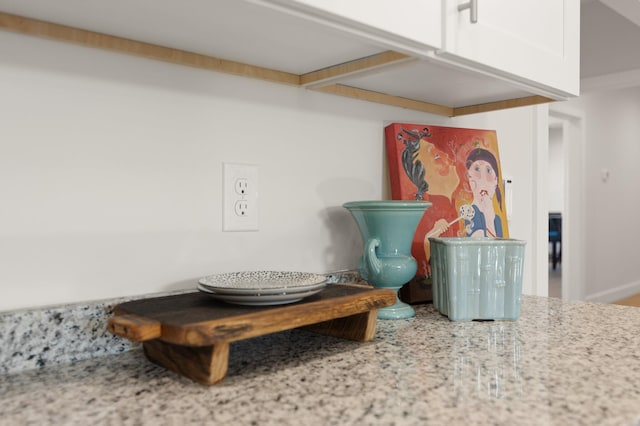 interior details with light stone counters and white cabinets