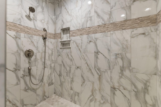 bathroom with a tile shower