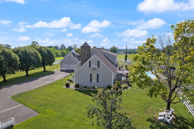 view of side of property with a lawn and a garage