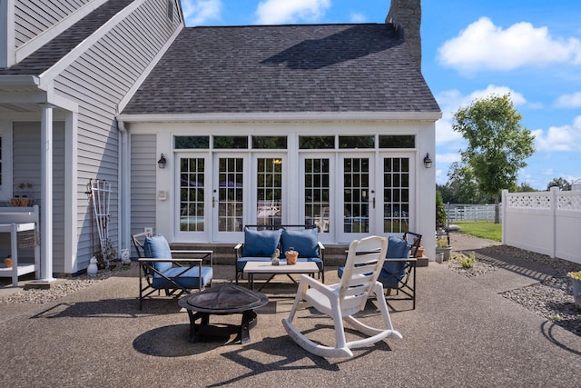 view of patio with french doors and an outdoor living space with a fire pit