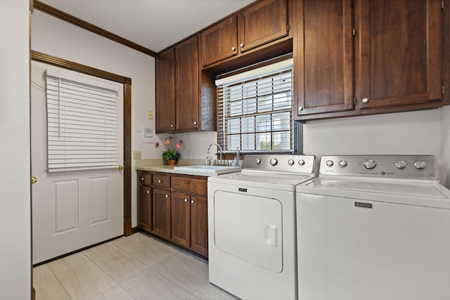 clothes washing area featuring cabinets, independent washer and dryer, sink, ornamental molding, and light tile patterned floors