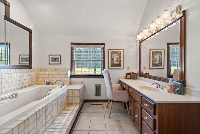 bathroom with tile patterned floors, vanity, tiled tub, and vaulted ceiling