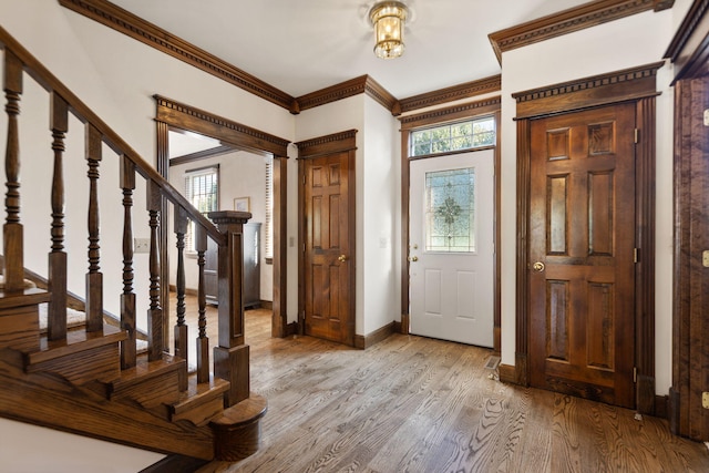 entryway featuring light hardwood / wood-style floors and ornamental molding