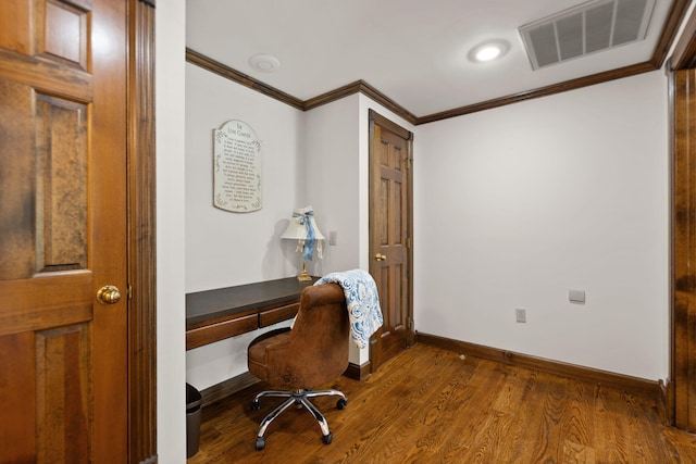 home office with built in desk, hardwood / wood-style floors, and crown molding