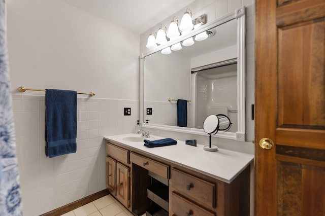 bathroom with tile patterned flooring, vanity, and tile walls