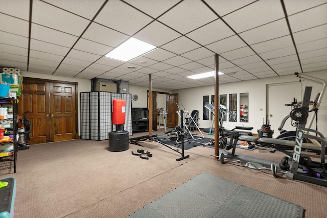 workout room with a drop ceiling and carpet