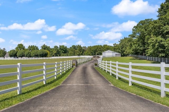 view of gate featuring a rural view and a yard