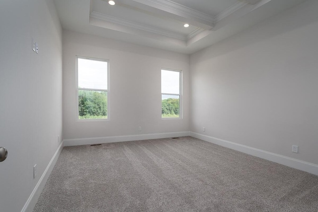 carpeted spare room featuring a raised ceiling, beam ceiling, and ornamental molding