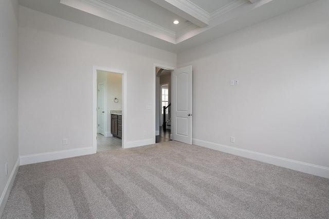 empty room with light colored carpet, ornamental molding, a tray ceiling, and beamed ceiling