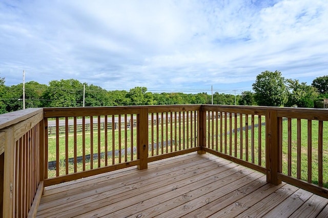 wooden terrace featuring a yard