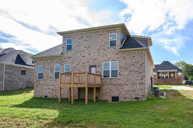 rear view of house featuring central AC unit, a wooden deck, and a yard