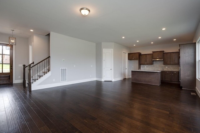 unfurnished living room with dark hardwood / wood-style flooring