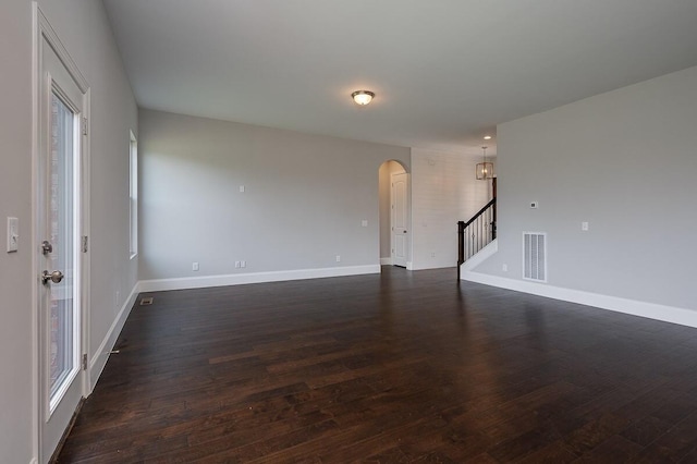 spare room with dark wood-type flooring