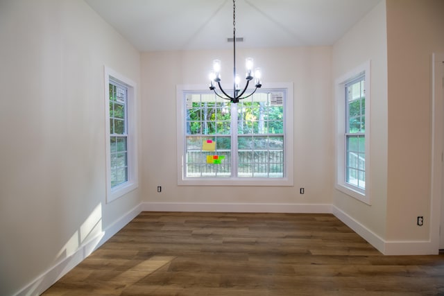 unfurnished dining area with dark hardwood / wood-style flooring and a healthy amount of sunlight