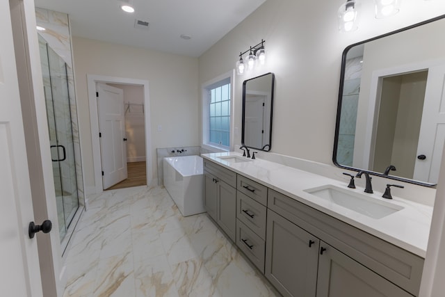 bathroom featuring shower with separate bathtub and vanity