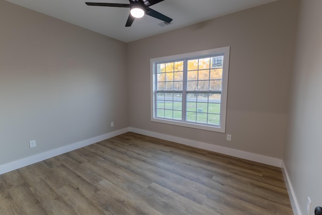 spare room with light hardwood / wood-style floors and ceiling fan