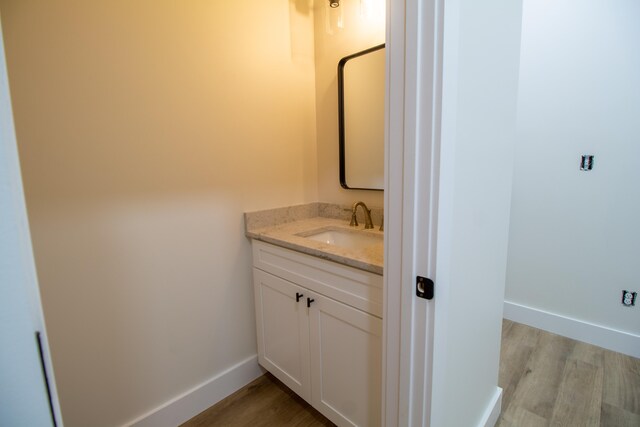 bathroom with vanity and hardwood / wood-style floors