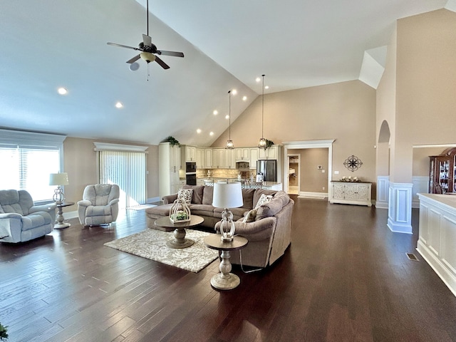 living room featuring high vaulted ceiling, dark hardwood / wood-style floors, and ceiling fan