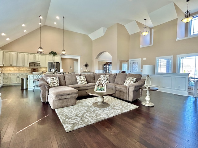 living room featuring dark hardwood / wood-style floors and high vaulted ceiling