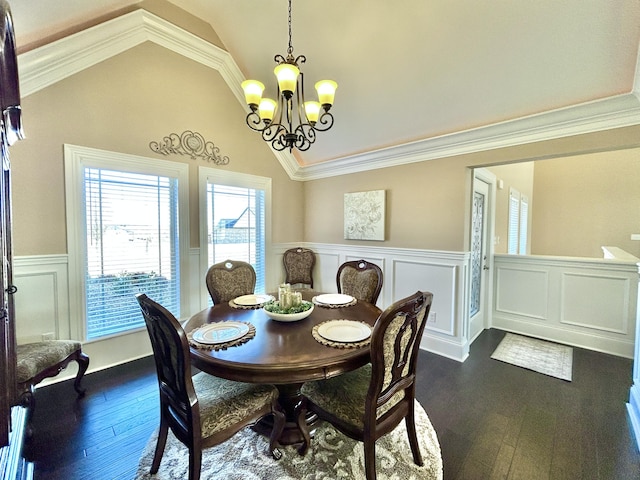 dining room with vaulted ceiling, dark hardwood / wood-style flooring, ornamental molding, and an inviting chandelier