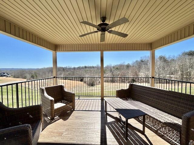 wooden deck featuring ceiling fan