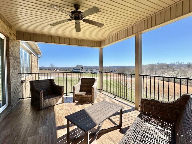 deck with outdoor lounge area and ceiling fan