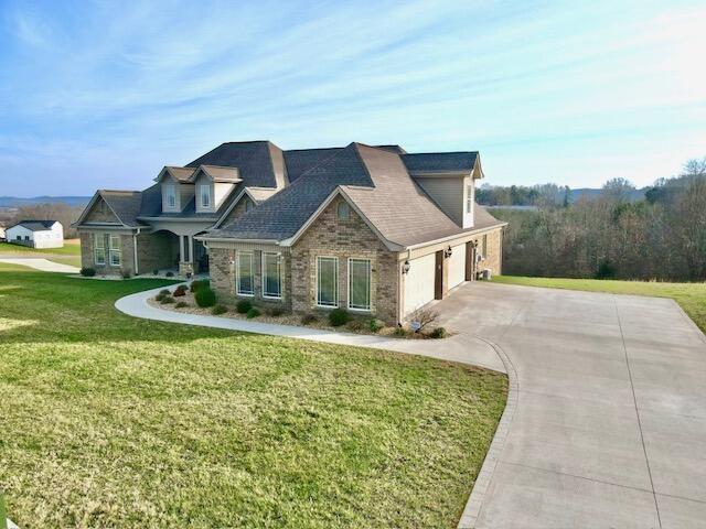 view of front of house featuring a garage and a front lawn