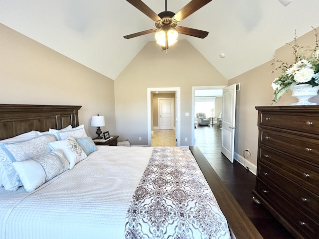 bedroom featuring ceiling fan, dark wood-type flooring, and high vaulted ceiling