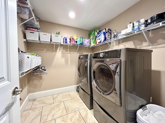 washroom featuring washer and dryer and light tile patterned floors