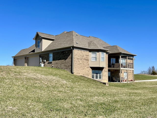 view of property exterior with a garage, a balcony, and a lawn