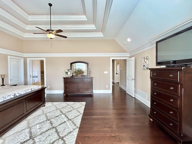 bedroom with ornamental molding, a tray ceiling, and dark hardwood / wood-style floors