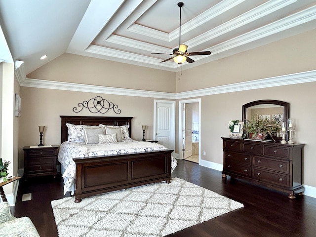 bedroom featuring crown molding, dark hardwood / wood-style floors, ceiling fan, and a tray ceiling