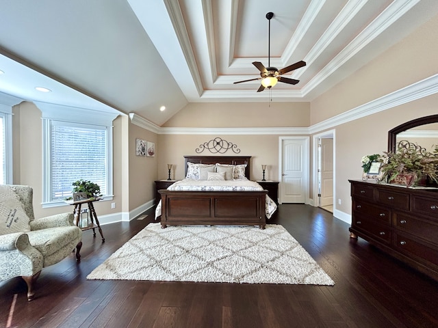 bedroom featuring a tray ceiling, ornamental molding, dark hardwood / wood-style floors, and ceiling fan