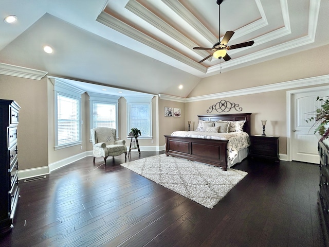 bedroom with crown molding, a tray ceiling, and dark hardwood / wood-style floors