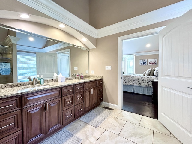 bathroom with vanity and ornamental molding