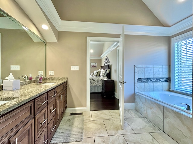 bathroom featuring lofted ceiling, tile patterned floors, vanity, ornamental molding, and tiled tub