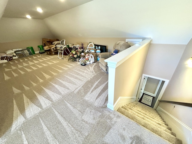 bonus room with vaulted ceiling and carpet