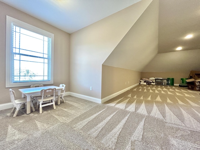 interior space with vaulted ceiling and carpet