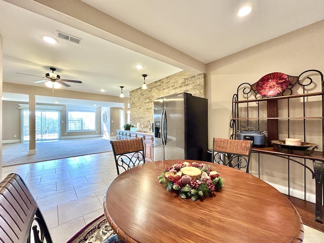 tiled dining room featuring sink and ceiling fan