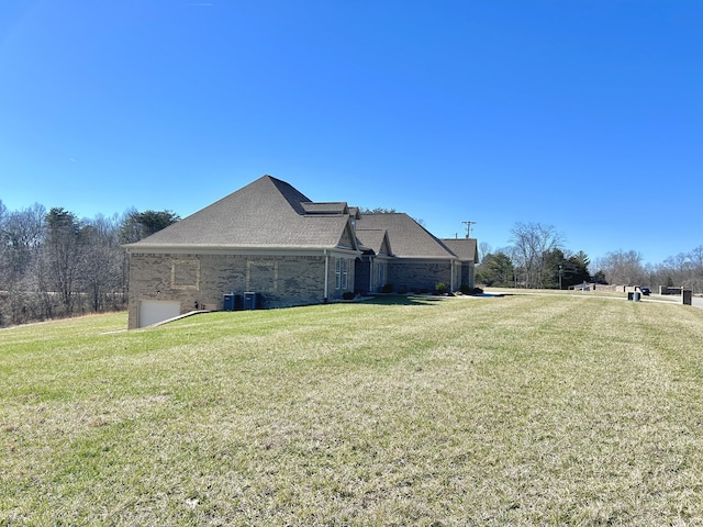 view of home's exterior with central AC unit and a lawn