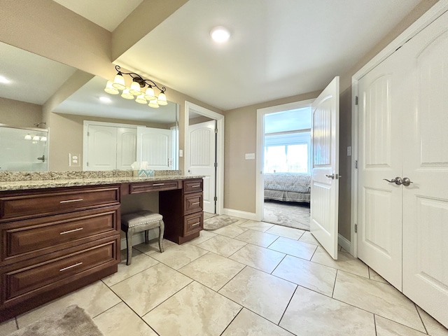 bathroom featuring vanity and a shower with door