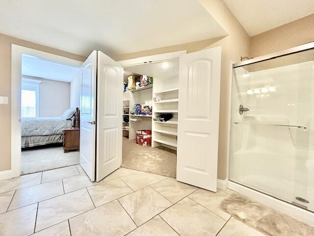 bathroom featuring a shower with shower door