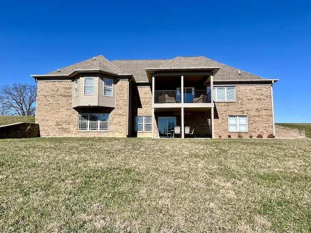 back of property with a balcony and a lawn