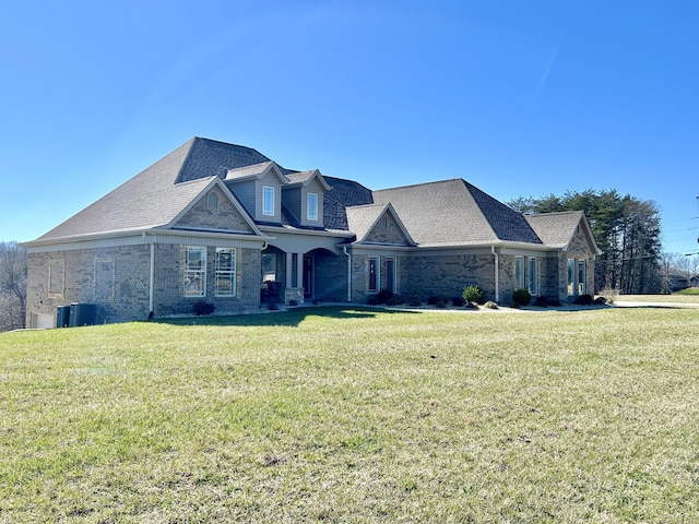 view of front of home with central AC unit and a front yard