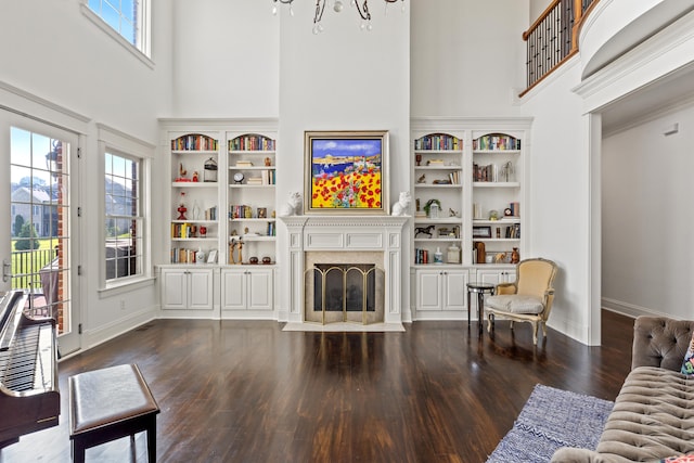 foyer entrance featuring dark wood-type flooring, french doors, a notable chandelier, and a healthy amount of sunlight