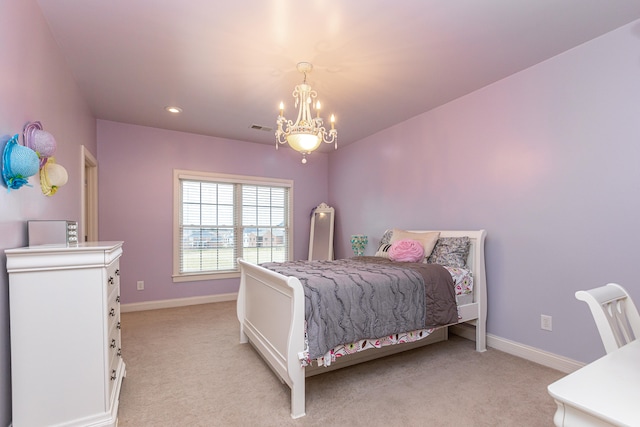 carpeted bedroom with a chandelier